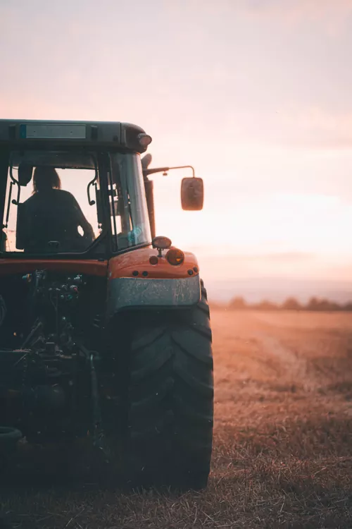 Agricultural tractor working in an open field